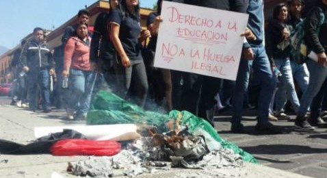 Maestros y estudiantes queman banderas rojinegras, exigen liberar la UABJO